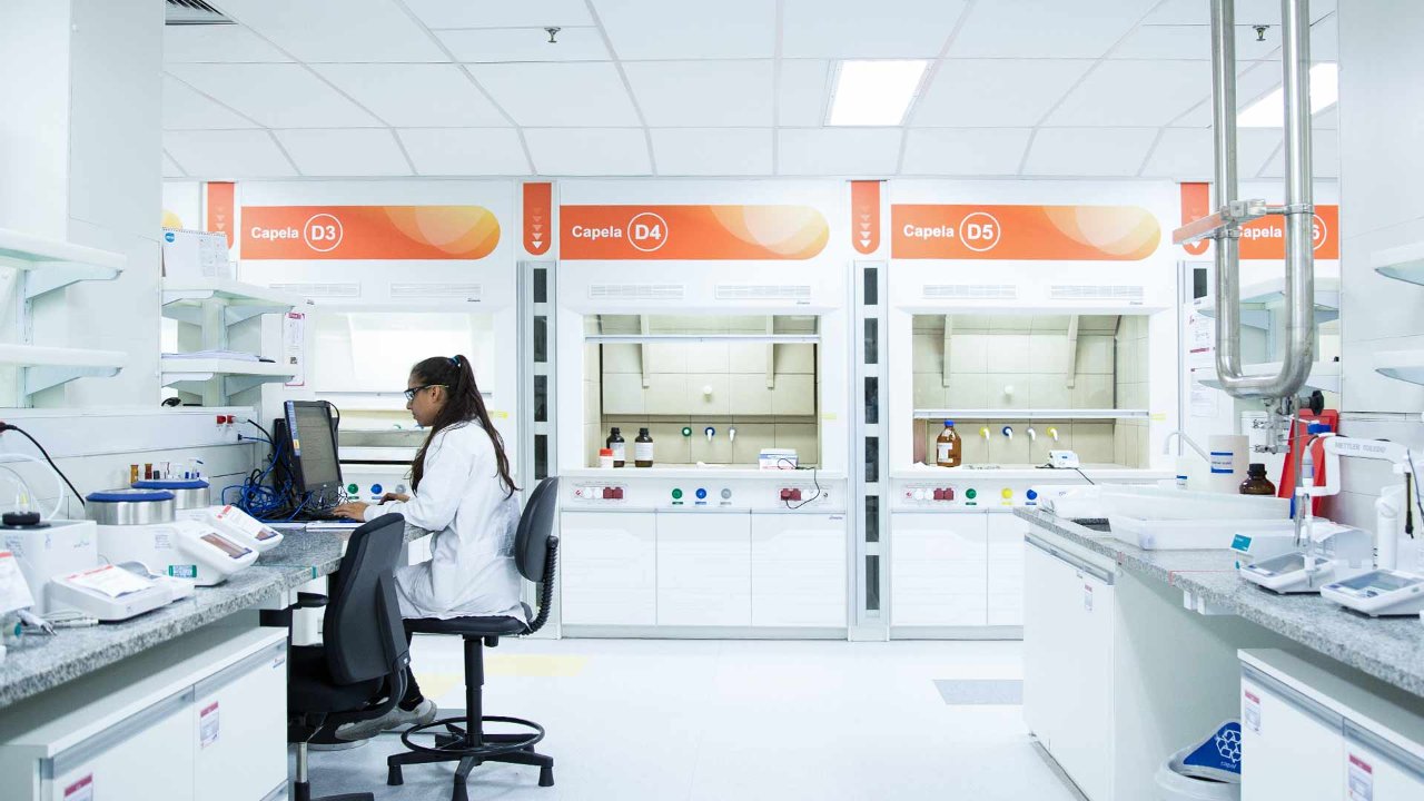 Woman working in a pharmaceutical lab surrounded by lab equipment