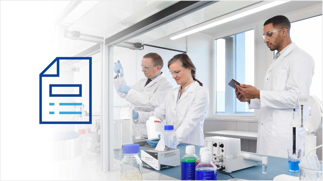 three scientists standing at a lab bench