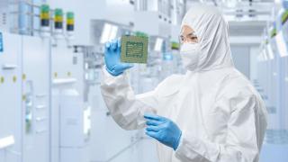 Lab analyst holding a semiconductor