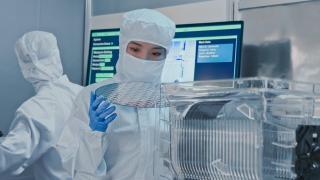 Lab analyst holding a semiconductor