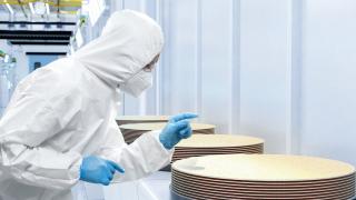 Researcher looking at a wafers